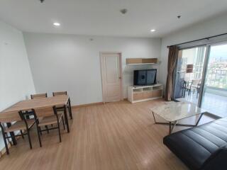 Spacious living room with dining area and a balcony view.