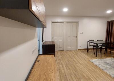 Living room with wooden flooring and dining area