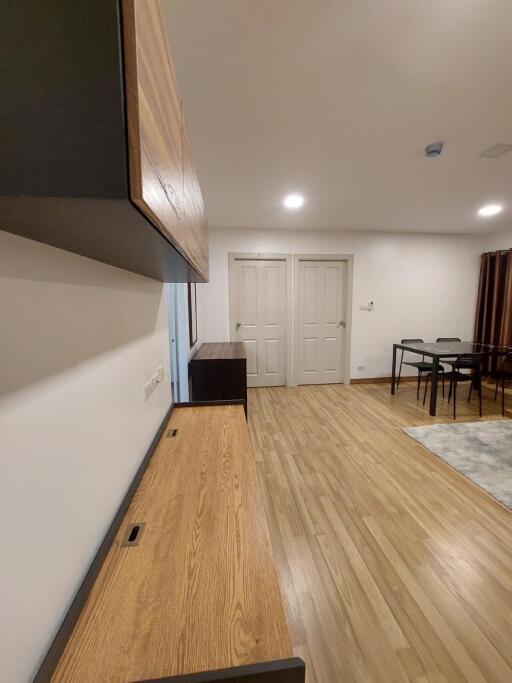 Living room with wooden flooring and dining area