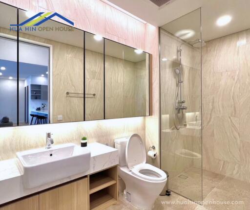 Modern bathroom with glass shower and large mirror