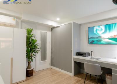 Modern bedroom with desk and TV