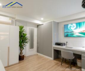 Modern bedroom with desk and TV