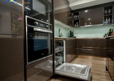 Modern kitchen with built-in appliances and open dishwasher