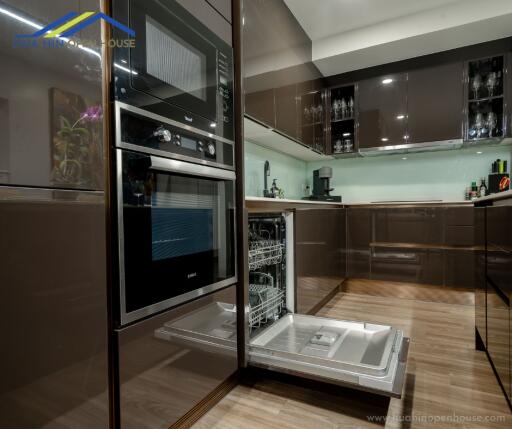 Modern kitchen with built-in appliances and open dishwasher