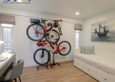 Bedroom with wall-mounted bicycles and work desk