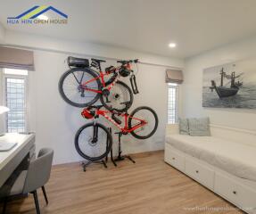 Bedroom with wall-mounted bicycles and work desk