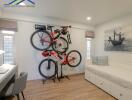 Bedroom with wall-mounted bicycles and work desk