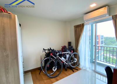 Bedroom with bikes and balcony view