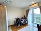 Bedroom with bikes and balcony view