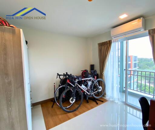 Bedroom with bikes and balcony view