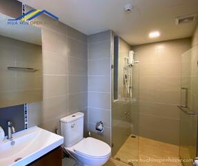 Modern bathroom with sink, toilet, and shower