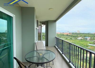 Spacious balcony with outdoor seating and scenic view
