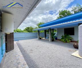 Outdoor view of the building with a gravel yard and some plants