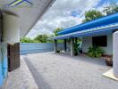 Outdoor view of the building with a gravel yard and some plants