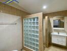 Bathroom with glass block shower and wall-mounted sink