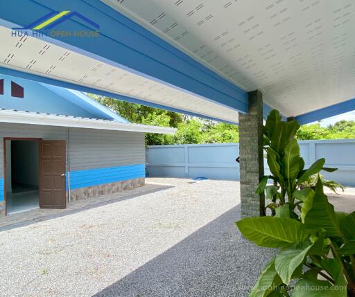 Outdoor view of a house with covered area and garden space