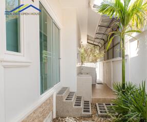 Outdoor space with plants and a small tiled patio