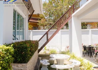 Outdoor seating area with stairs and garden