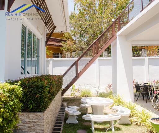 Outdoor seating area with stairs and garden