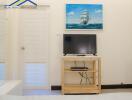 Living room with a TV and a painting of a ship