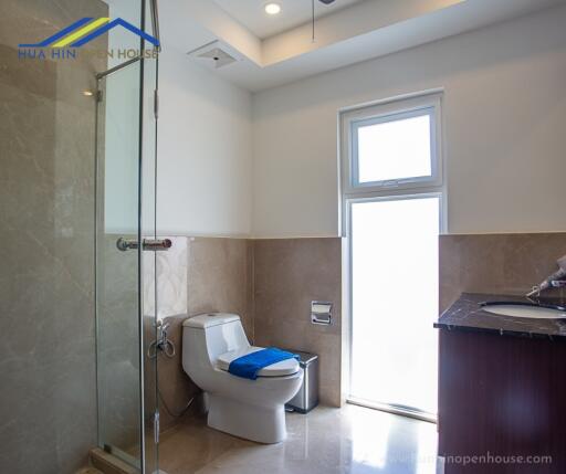 Modern bathroom with glass shower and window