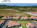 Aerial view of residential villas with green surroundings