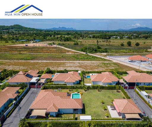 Aerial view of residential villas with green surroundings