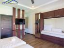 Modern bedroom with wooden floors, built-in furniture, and mounted TV