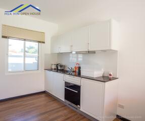 Modern kitchen with white cabinets and appliances