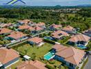 Aerial view of a residential neighborhood with houses and green lawns