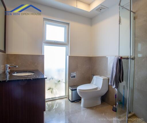 Modern bathroom with sink, toilet, and glass shower