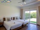 Spacious bedroom with two single beds and garden view