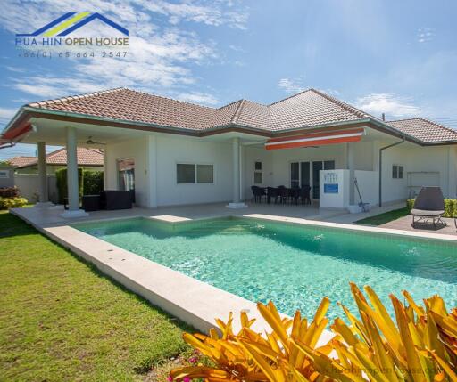 Outdoor view of a house with a swimming pool and patio