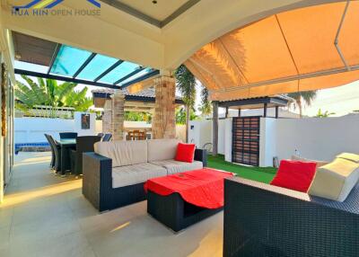 Spacious outdoor living area with seating and dining arrangement