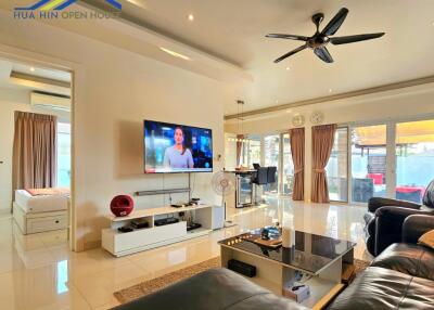 Spacious living room with modern furnishings and amenities