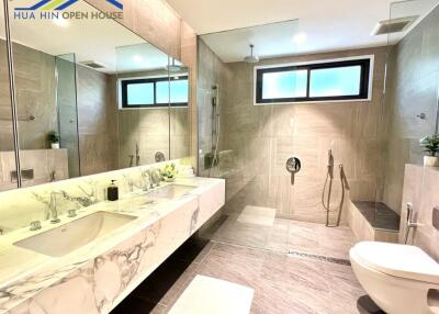 Spacious modern bathroom with large mirror and double sinks