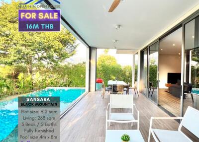 Spacious and luxurious main living area with a modern design, large glass walls, and pool view
