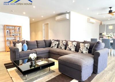Modern living room with sectional sofa and open shelving