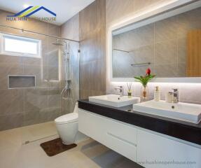 Modern bathroom with double sink and shower