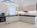 Modern kitchen with white cabinetry and built-in appliances