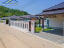 Modern residential homes with gated walls and surrounding greenery