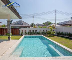 Beautiful outdoor swimming pool with clear water and surrounding greenery