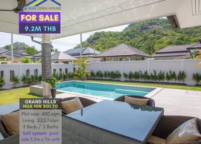 Outdoor view of a luxurious patio with a swimming pool and mountain backdrop