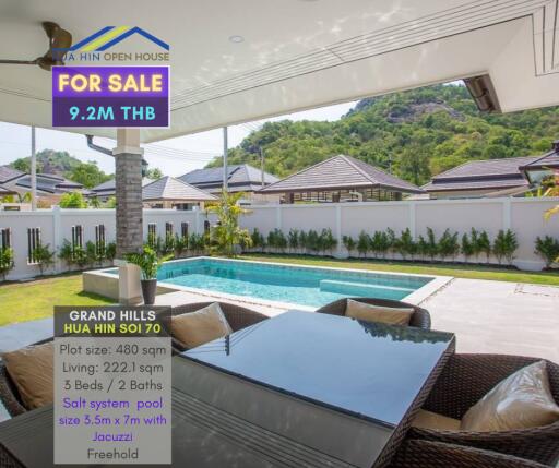 Outdoor view of a luxurious patio with a swimming pool and mountain backdrop