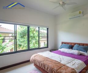 Bedroom with a large window and modern furnishings