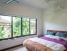 Bedroom with a large window and modern furnishings