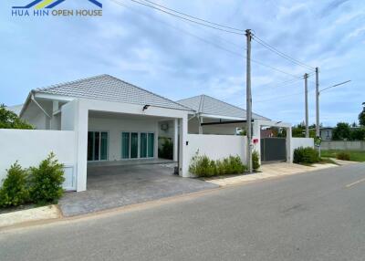 Exterior view of a single-story house with a garage and driveway