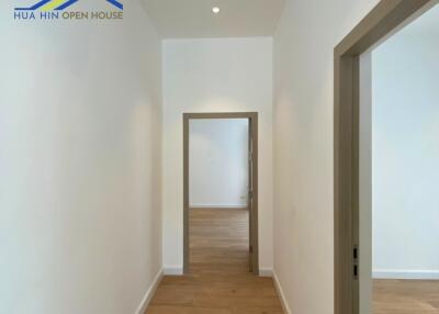 Clean and bright hallway with wooden flooring