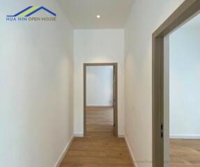 Clean and bright hallway with wooden flooring