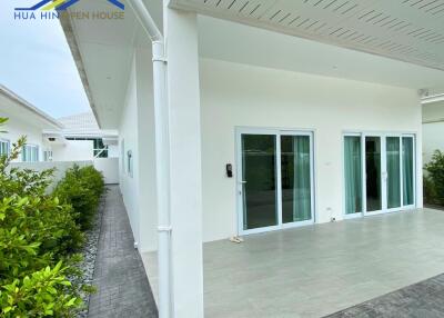 Exterior view of the house featuring sliding glass doors